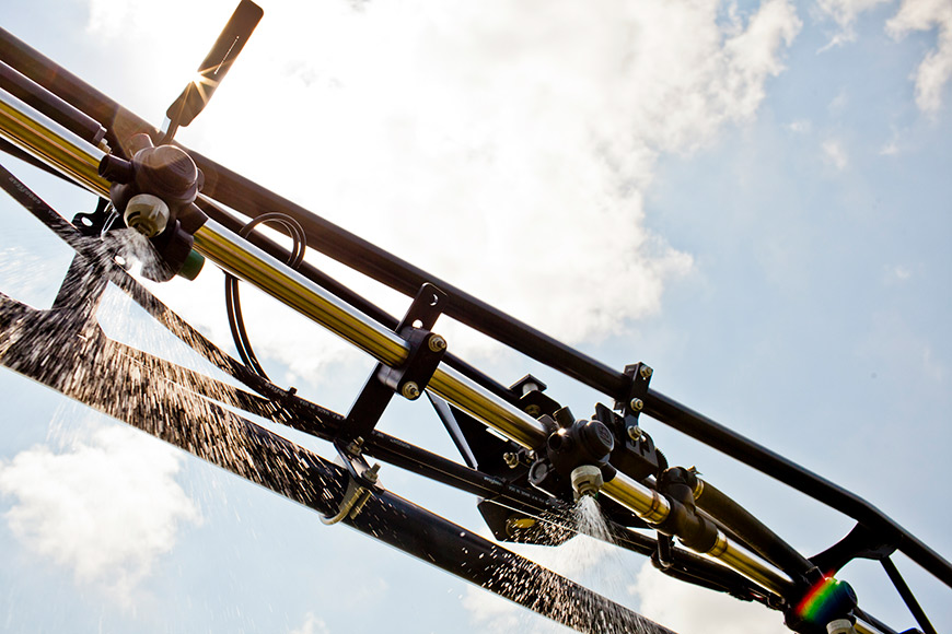 sprayer spraying product into field