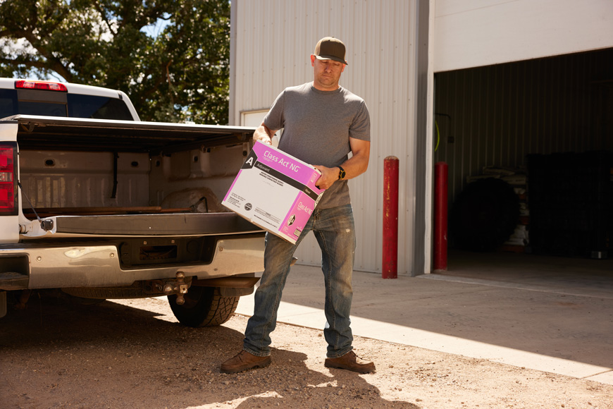 Man unloading WinField United Class Act® NG® adjuvant from truck