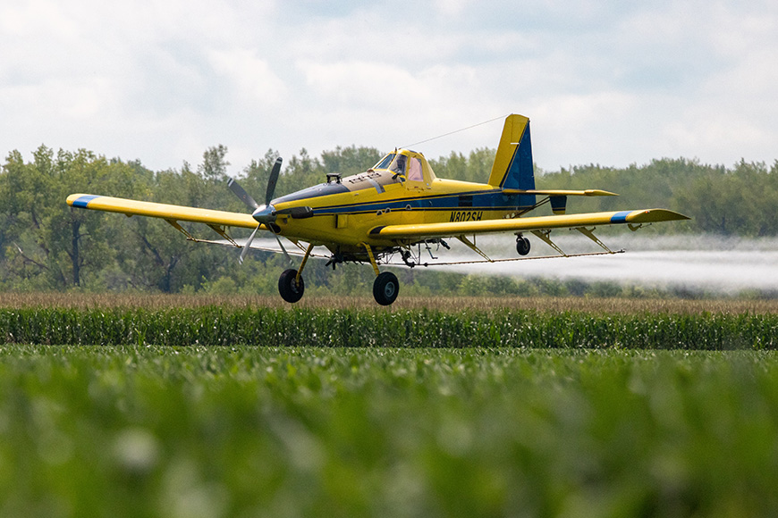 Airplane applying crop protection to a soybean field.