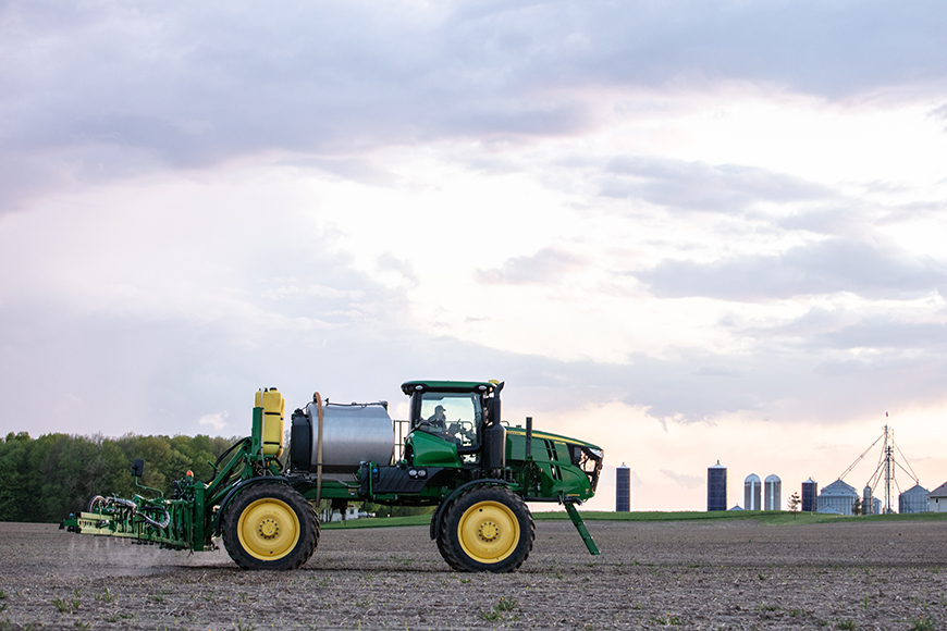 Farmer spraying an early-season Enlist One herbicide application on a soybean field.