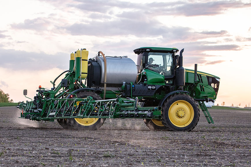 Farmer spraying an early-season Enlist One herbicide application on a soybean field 